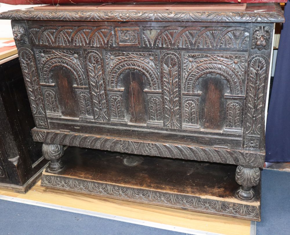 An 18th century and later carved oak fall front cabinet, (altered) W.127cm, D.51cm, H.104cm